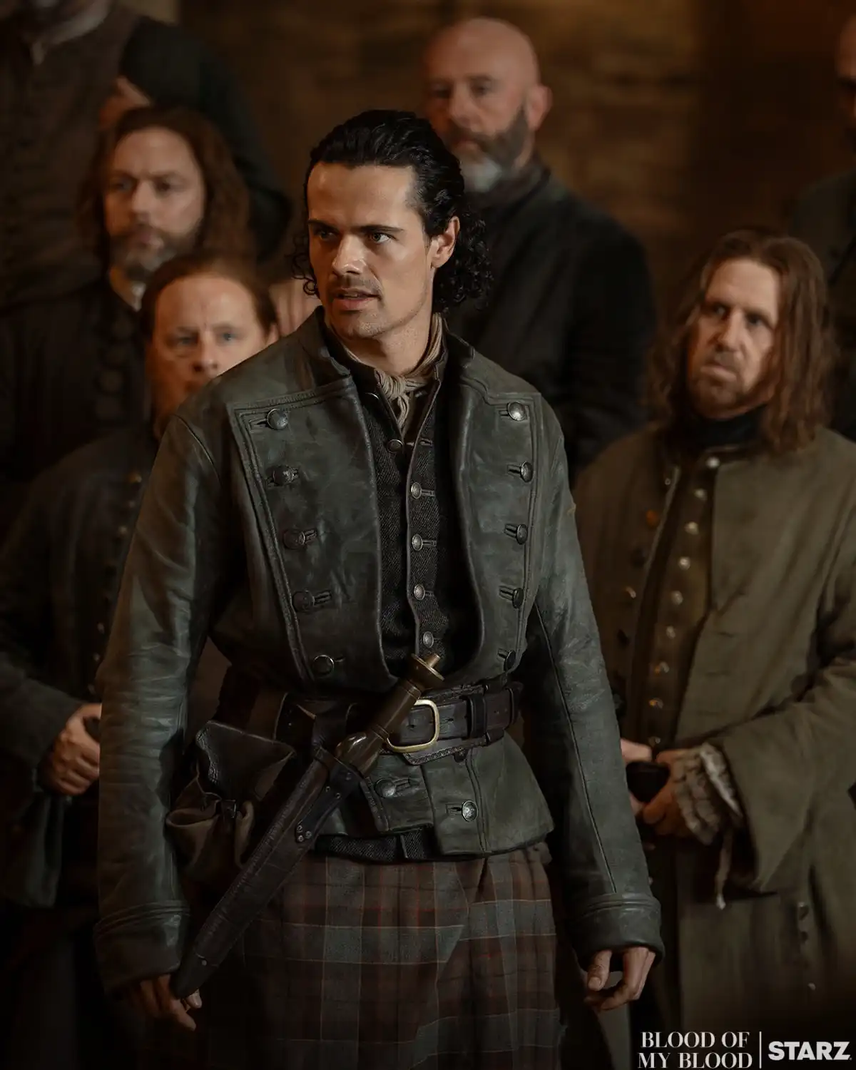 Brian Fraser entouré d'hommes dans une salle de château